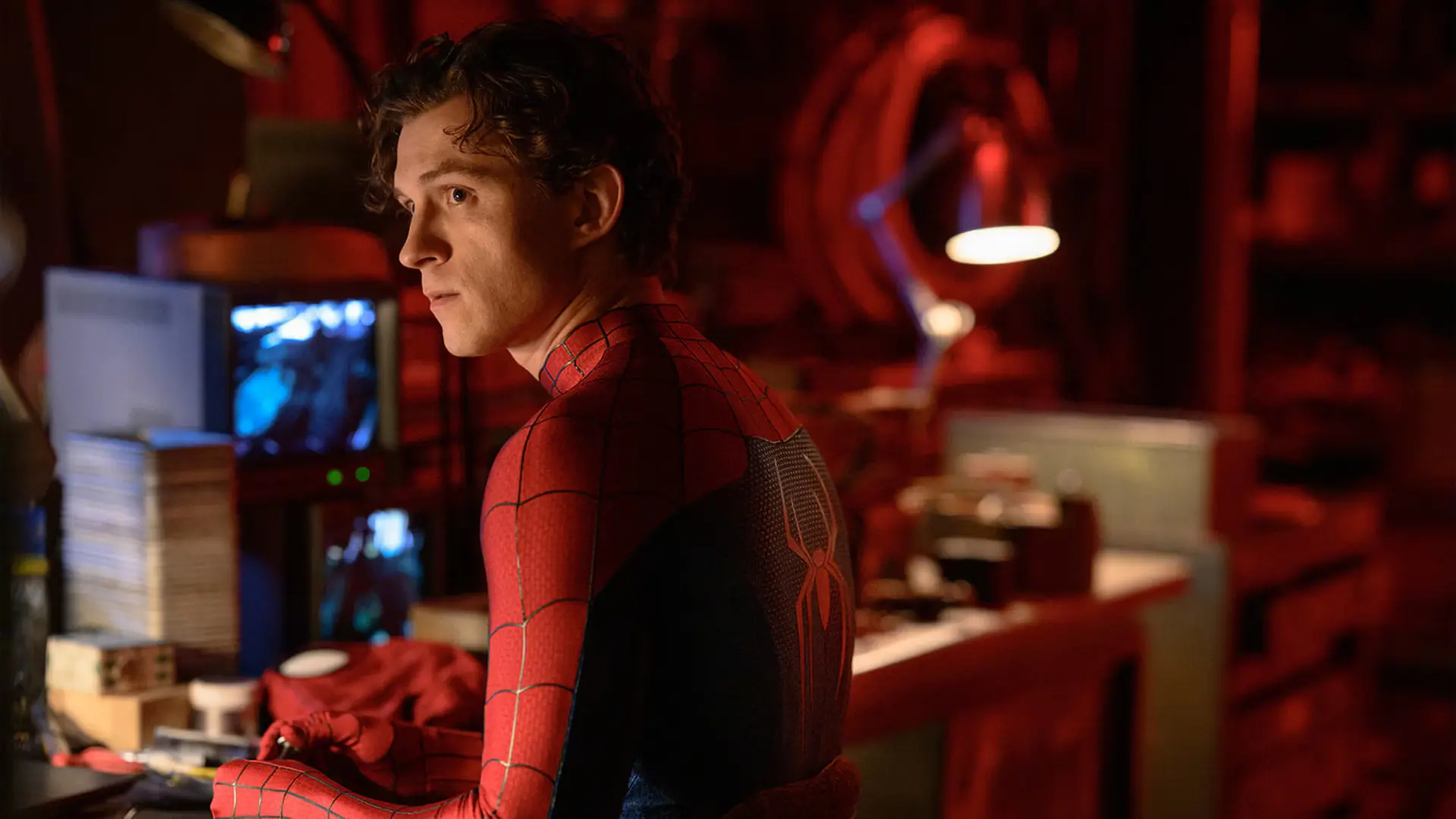 پیتر پارکر (Peter Parker) با لباس قرمز و مشکی مرد عنکبوتی در محیطی تاریک