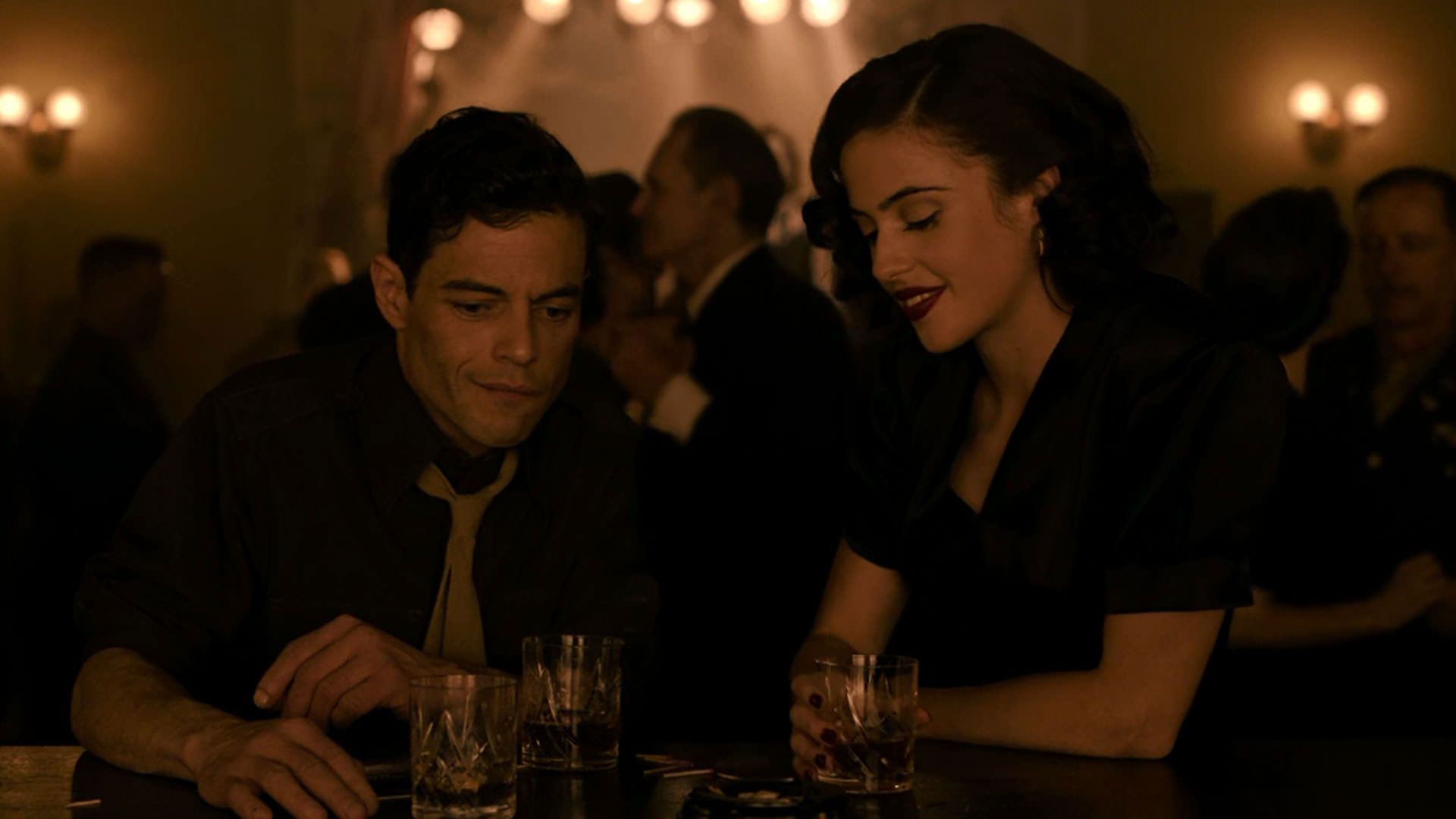 رامی مالک نشسته کنار لیدیا پکهام داخل یک بار در فیلم نورنبرگ جیمز وندربیلت